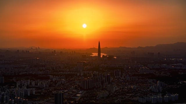 City skyline transitioning from sunset to night