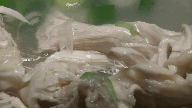 Chicken from ginseng chicken soup split with chopsticks