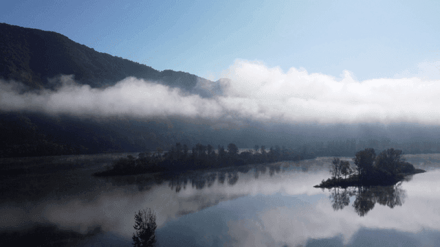 Misty mountains and tranquil lake