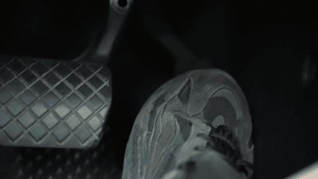 Foot pressing a car pedal