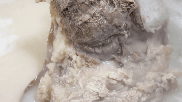 Beef soup broth boiling in pot