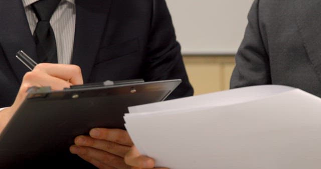 Office Workers Reviewing Documents at Work