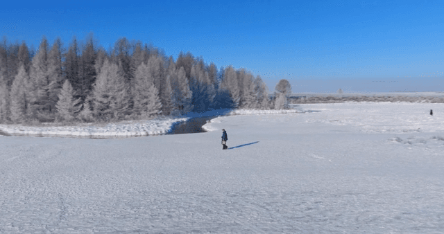 Snowy landscape and a person walking alone
