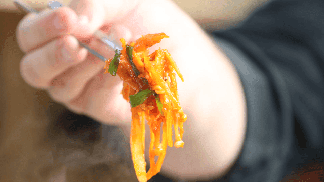 Spicy grilled burdock picked up with chopsticks