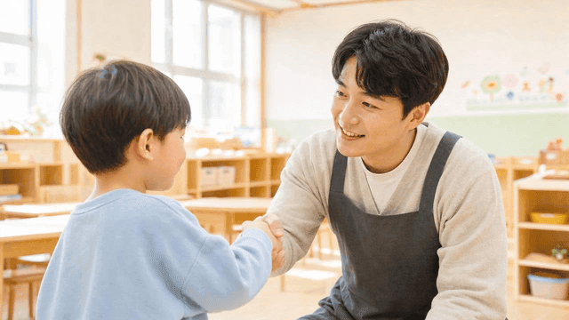 Teacher and child shaking hands at kindergarten