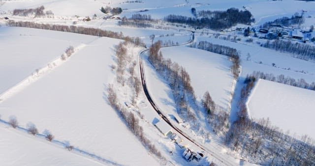 Snowy Landscape with a Road Crossing