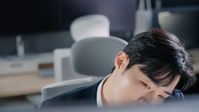 Man talking on the phone at his desk