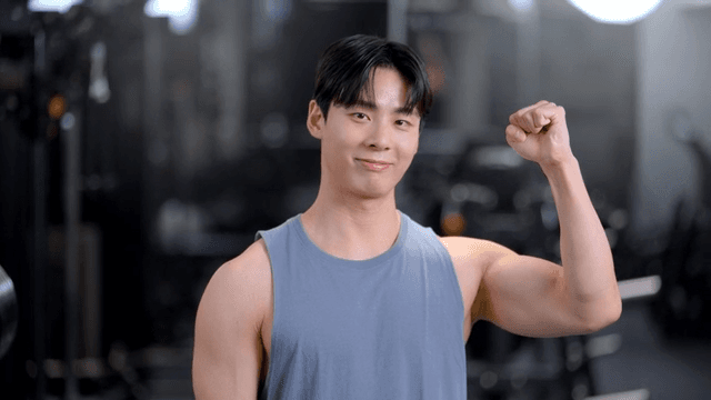 헬스장에서 정면을 보고 웃으며 응원하는 젊은 남성