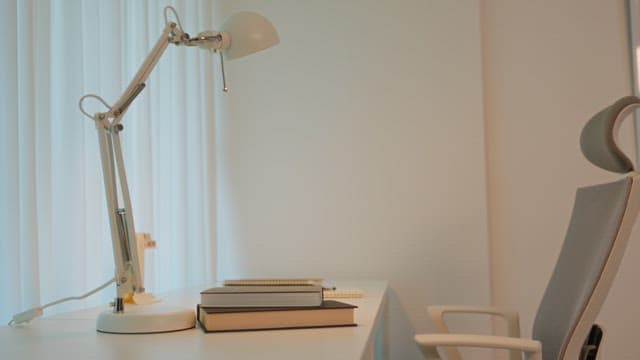 Man writing at a desk in a calmly lit room