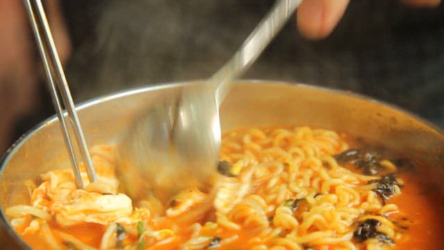 Cooking spicy ramen with vegetables