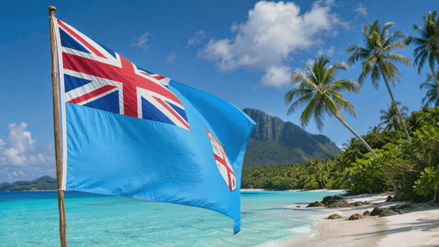 Fijian flag on palm trees and clear seashore