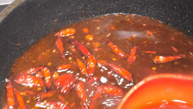 Making a sauce with lots of hot peppers
