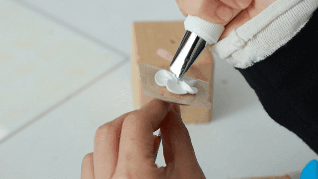 Piping bag for decorating flower-shaped icing on board