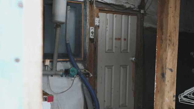 Old rural room door with pipes