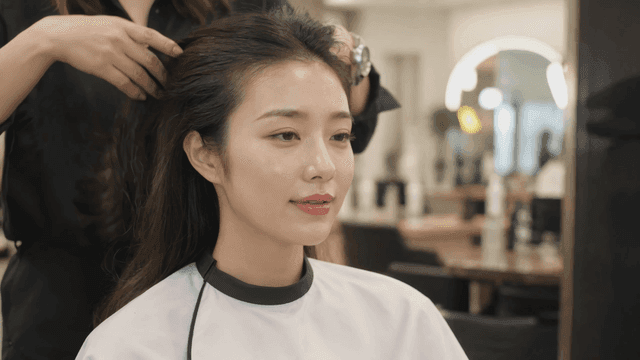 Woman getting her hair styled at a salon