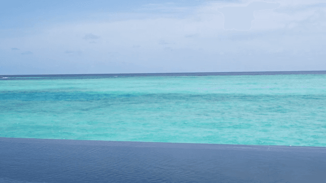 Overwater bungalows by a turquoise sea