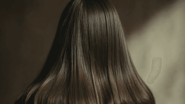Back view of woman with long, soft, straight hair