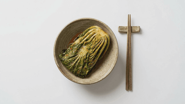 Fresh spring cabbage kimchi served with chopsticks