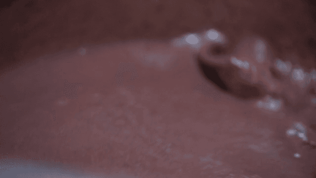 Stirring the boiling red bean porridge