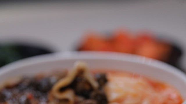 Bowl of spicy noodles with chopsticks