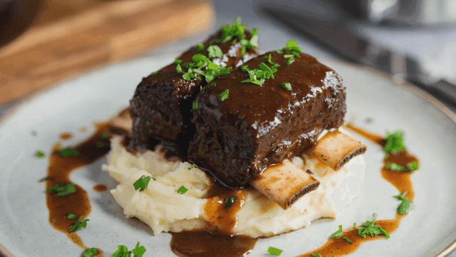 Braised beef short ribs on top of mashed potatoes