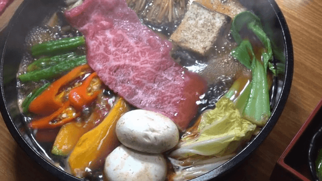 Pot of sukiyaki with fresh ingredients