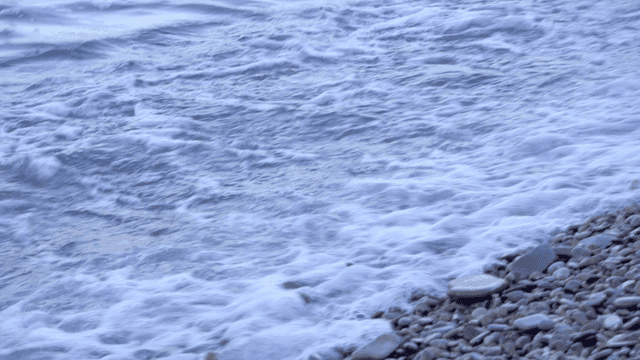 Waves gently lapping on a pebble beach