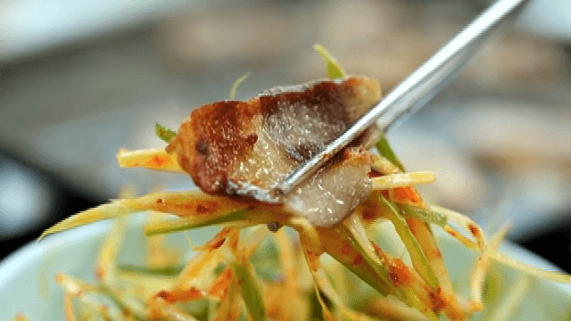 Picking up pork with Green Onion Salad