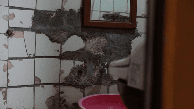 Old bathroom with cracked tiles