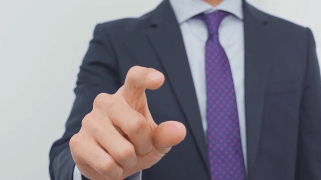 Businessman Gesturing Instruction with His Finger