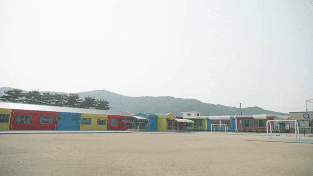 Colorful elementary school with mountain backdrop