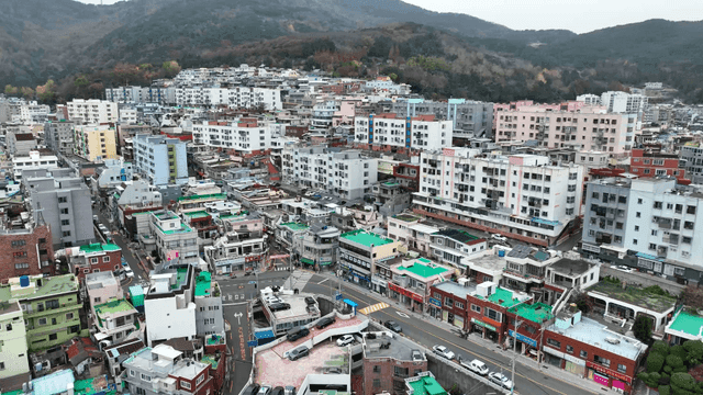 Aerial view of a dense urban area with hills