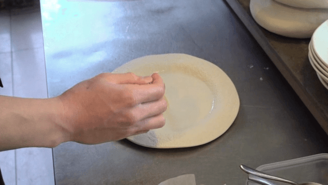 Chef preparing a dish with sauce