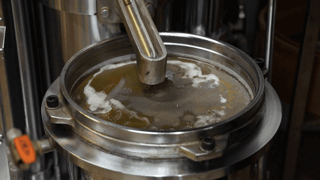 Sesame oil filtered into metal container
