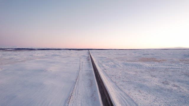 Long road through a snowy landscape