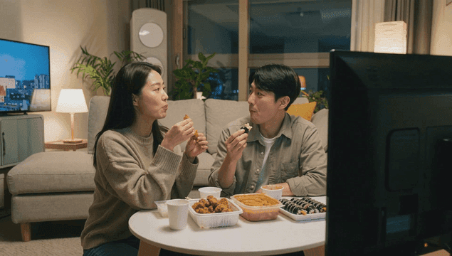 Couple enjoying delivery food in comfort of their home