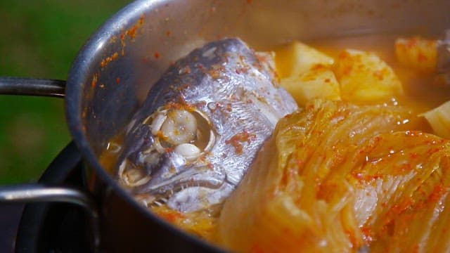 Kimchi stew with tofu and fish in a pot