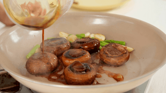 Mushrooms and vegetables cooking in a pan