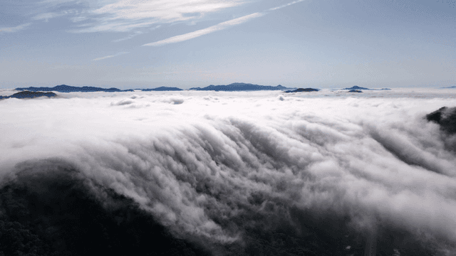 Vast clouds spread over mountain