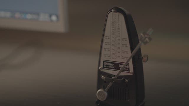 Metronome on a Music Stand Against a Blurred Background