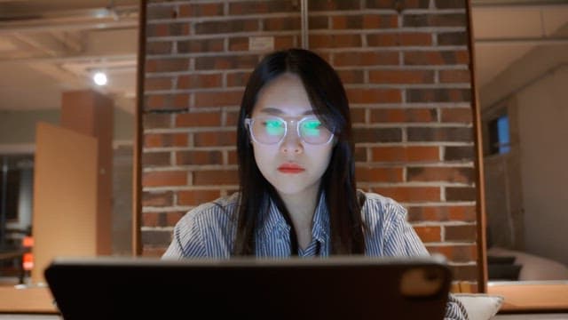 Woman working on a laptop indoors