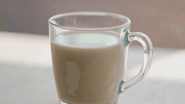 Glass of milk on table