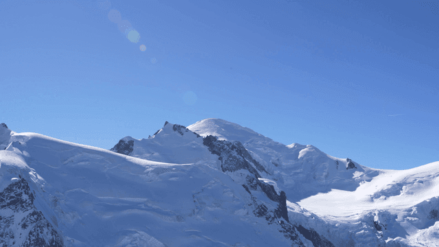Snow-covered mountain peaks under a clear blue sky