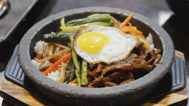 Bibimbap and fried eggs in stone pot