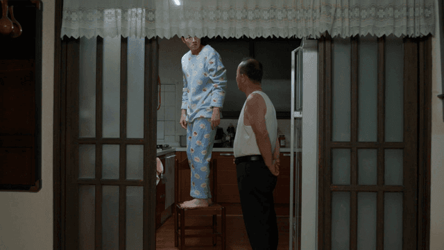 Father and son talking in kitchen