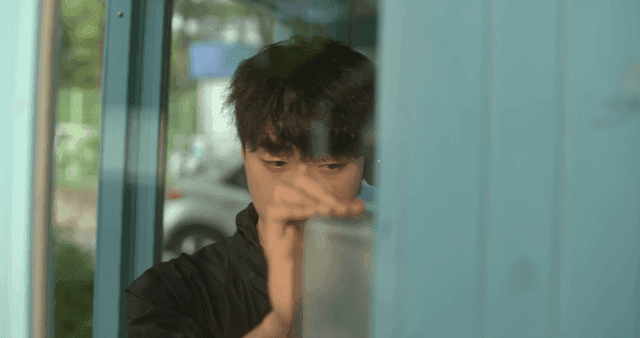 Young man making a phone call in a booth