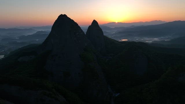 Dawning Sky and Silhouette of Majestic Mountain Peak