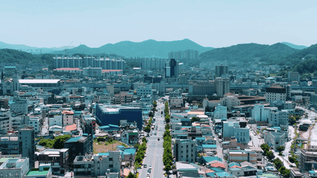 Bustling city with mountains visible in distance