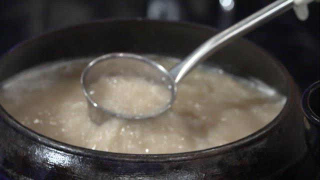 Pouring Broth into Bowl of Seolleongtang with Meat