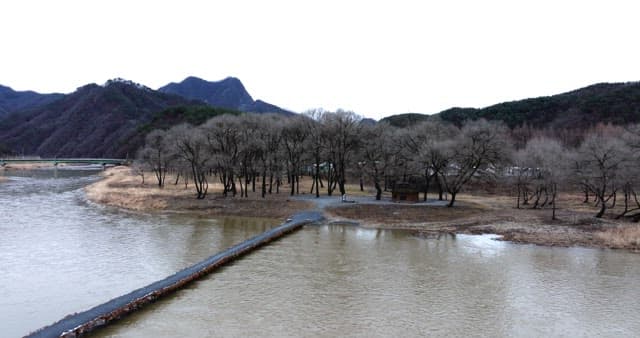 Peaceful river landscape surrounded by mountains and trees